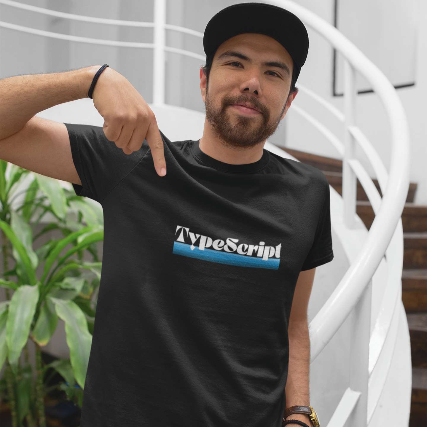 A male software developer wearing a t-shirt that says "TypeScript"